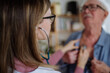 © Halfpoint - Doctor visiting senior man and examinig him with stethoscope indoors at home, listening to heartbeat.