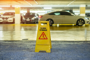 Sign showing warning of caution wet floor in garage building