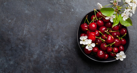 Wall Mural - Ripe cherry in bowl with cherry blossom