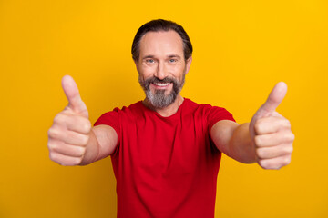 Poster - Photo of impressed mature brunet man thumb up wear red t-shirt isolated on yellow color background