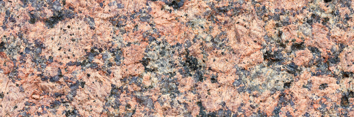 Wall Mural - Granite texture. Natural pink granite with a grainy pattern. Stone background. Solid rough surface of rock. Durable construction and decoration material. Close-up.