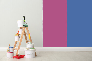 Wall Mural - Decorator's kit of tools and paints near wall indoors