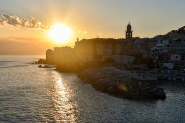 Wall Mural - Backlight view of the old fishing village in the Italian Riviera with the small port at sunset, Nervi, Genoa, Liguria, Italy	