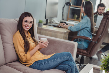 Wall Mural - Portrait of group corporate partners positive lady sit sofa enjoy coffee break project development indoors