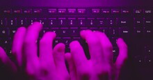 Typing On Keyboard In Neon Lights Closeup
