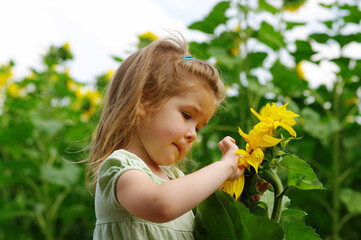 Wall Mural -  girl and sunflower on the field