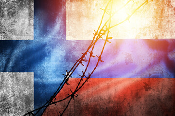 Wall Mural - Grunge flags of Russian Federation and Finland divided by barb wire sun haze illustration