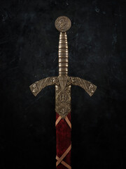 Vertical closeup of a knight's sword with a bronze handle