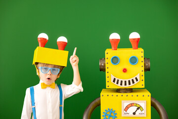 Wall Mural - Happy child with toy robot in class