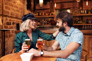 Caucasian couple having a drink at a bar.