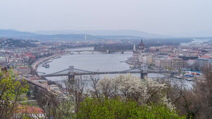 Wall Mural - Time lapse of Budapest Danube river with bridges and Parliament building at sunset, blue hour and illuminated cityscape