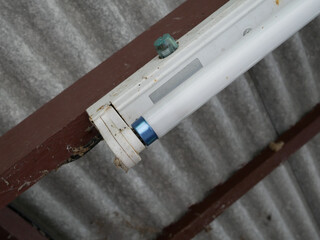 closeup of old fluorescent light tube on the ceiling.	