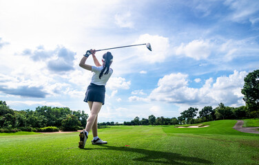 Professional woman golfer teeing golf in golf tournament competition at golf course for winner