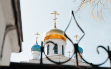 Religion And Faith Concept. White Church With Gold And Blue Domes And Crosses, Outdoors