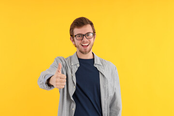 Wall Mural - Concept of people, young man on yellow background