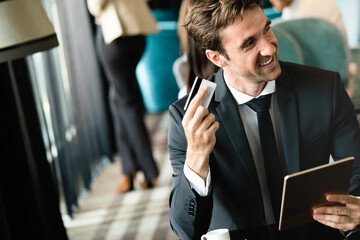 Poster - Portrait of happy successful businessman holding tablet