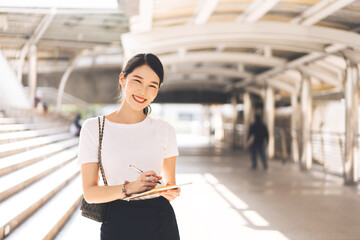 Wall Mural - Portrait of young adult business working asian beauty woman holding a digital tablet.