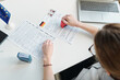 © AnnaStills - High angle view shot of unrecognizable woman working as consular officer in embassy putting rejection seal on visa application form