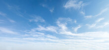 Wide angle photo of sunny and windy weather sky with blue tones. Summer or spring sky with cloudscape.