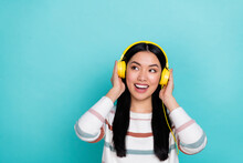 Photo Of Impressed Young Lady Listen Music Look Promo Wear Headphones White Pullover Isolated On Turquoise Color Background