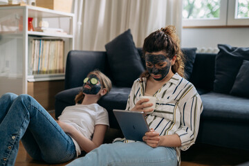 mother and daughter feeling enjoyable at home. they have spa weekend at home