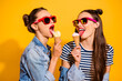 © deagreez - Photo of two ladies have free time eat tasty fresh ice cream wear denim jeans isolated shine color background