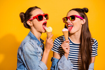 Photo of two ladies have free time eat tasty fresh ice cream wear denim jeans isolated shine color background