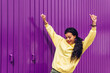 © Dani D.G - Cheerful young woman dancing on street and looking at camera on sunny day