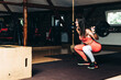 © Djordje - Attractive young sports woman with barbell. Doing squats. Fron view of beautiful girl squatting..