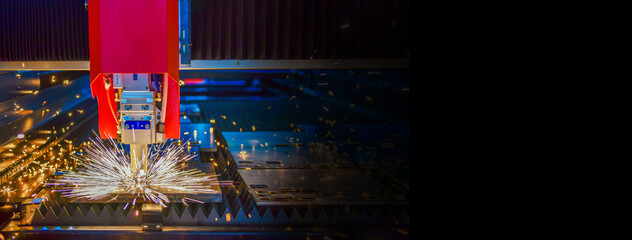 Wall Mural - industrial laser cut machine while cutting the sheet metal with the sparking light. copy space