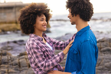 Romantic Young African American Afro Couple Smiling While Looking Each Other Face To Face At Beach