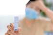 © Tom Wang - woman holding Rapid Antigen Test kit with Positive result during swab COVID-19 testing