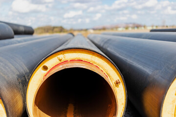 Wall Mural - Insulated pipe. Large metal pipes with a plastic sheath at a construction site. Modern pipeline for supplying hot water and heating to a residential area.