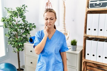 Sticker - Young caucasian woman working at pain recovery clinic touching mouth with hand with painful expression because of toothache or dental illness on teeth. dentist