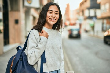 Wall Mural - Young middle east student girl smiling happy standing at the city.