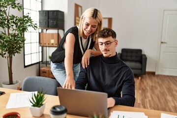 Canvas Print - Two business workers smiling happy working using laptop at the office.