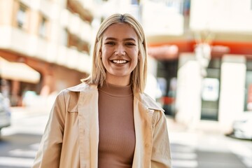 Poster - Young blonde girl smiling happy standing at the city.