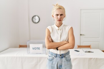 Sticker - Beautiful caucasian woman standing by voting ballot at election room skeptic and nervous, disapproving expression on face with crossed arms. negative person.