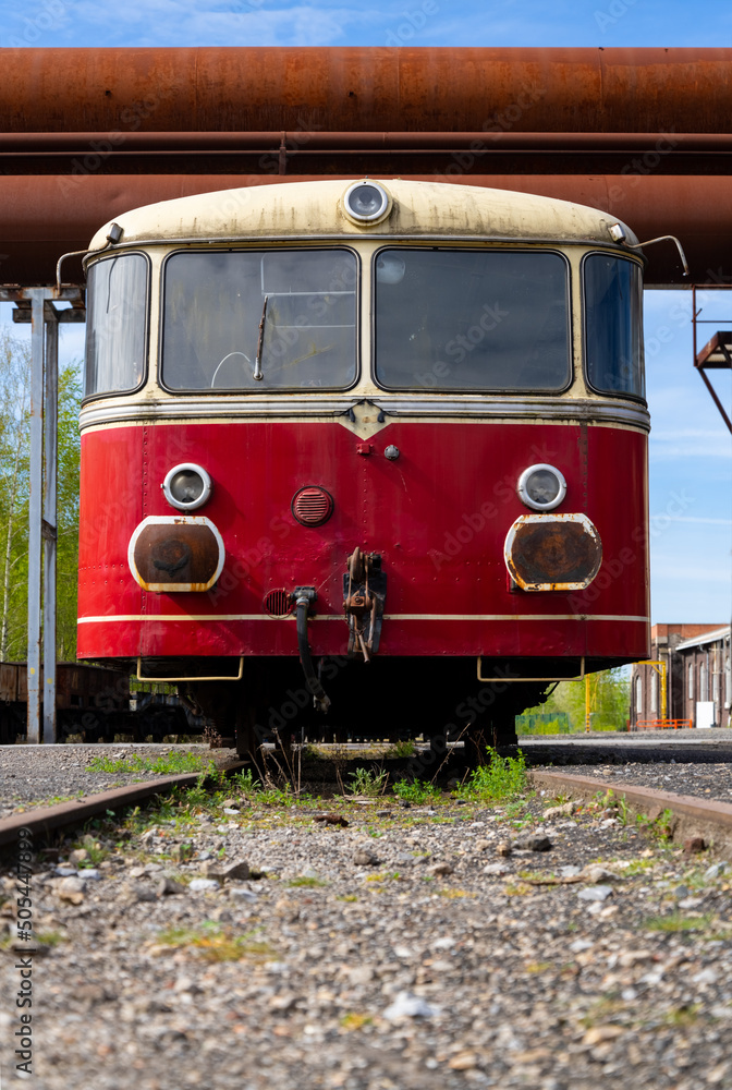 Frontal view of a historic red railcar called “Schienenbus“ on a side ...