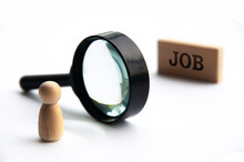 Selective Focus Of Wooden Doll Looking Through Magnifying Glass Seeking For Job.