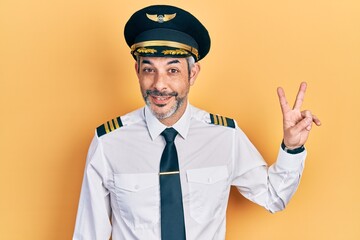 Sticker - Handsome middle age man with grey hair wearing airplane pilot uniform showing and pointing up with fingers number two while smiling confident and happy.