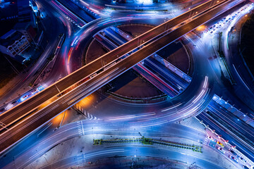 Aerial view of car traffic transportation above circle roundabout road of Drone aerial view fly , high angle. Public transport or commuter city life concept of economic and energy, infrastructure	
