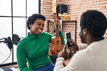 Poster - African american man and woman music group make photo holding ukelele at music studio