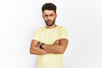 Sticker - Arab young man standing over isolated background skeptic and nervous, disapproving expression on face with crossed arms. negative person.