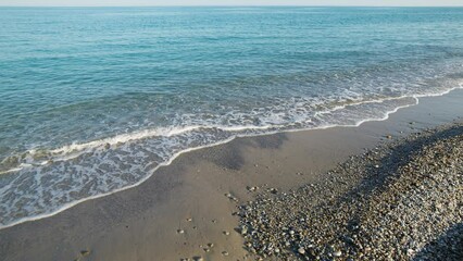 Wall Mural - Beach with sea and calm waves in Summer in Sicily.
