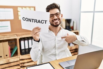 Sticker - Young man with beard holding contract paper at the office pointing finger to one self smiling happy and proud