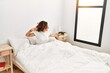 © Krakenimages.com - Mature hispanic woman waking up from bed at the bedroom