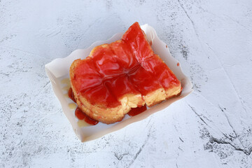 Sweet bread with strawberry jam, toast with Strawberry jam in paper box on stone background