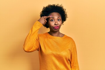 Wall Mural - Young african american woman wearing casual clothes pointing unhappy to pimple on forehead, ugly infection of blackhead. acne and skin problem