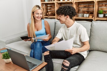 Poster - Young couple controlling family economy at home.